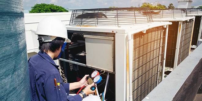 technician checking AIR CONDITIONING system