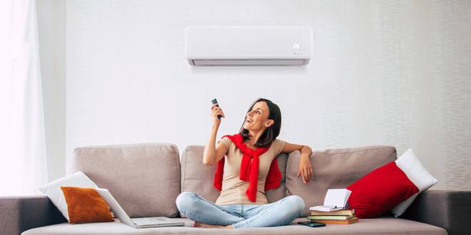 happy homeowner receiving the advantages of a Residential Air Conditioner service In Tulsa, OK